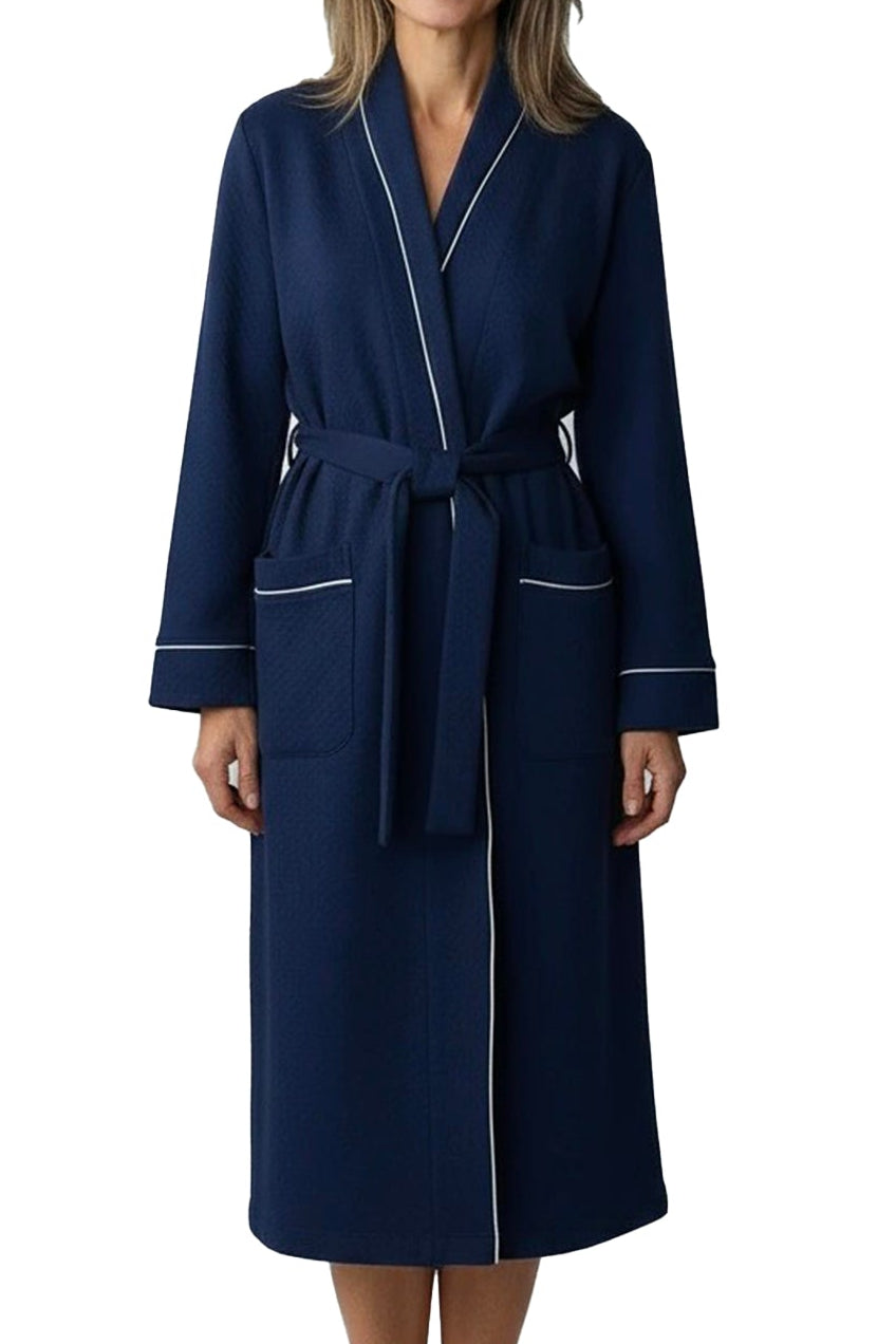 Woman wearing a navy blue robe with white trim on a white background